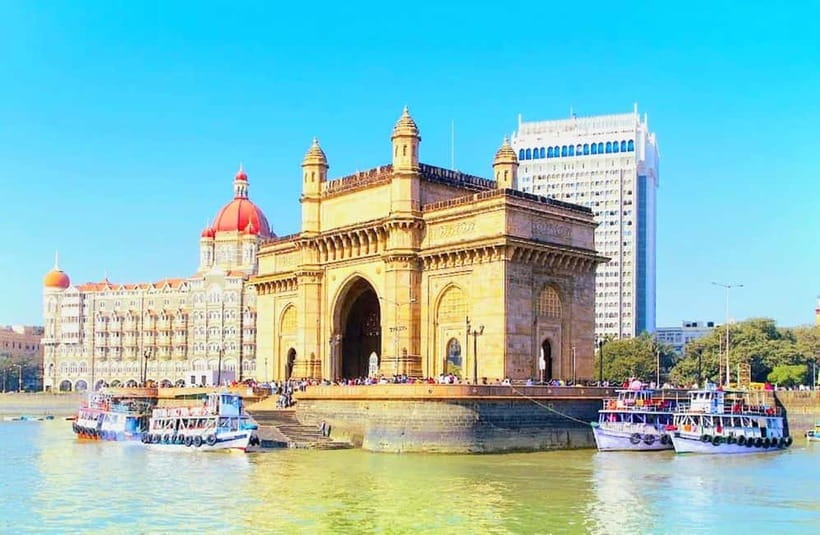 The Gateway of India and the Taj Mahal Palace hotel seen across Mumbai harbour