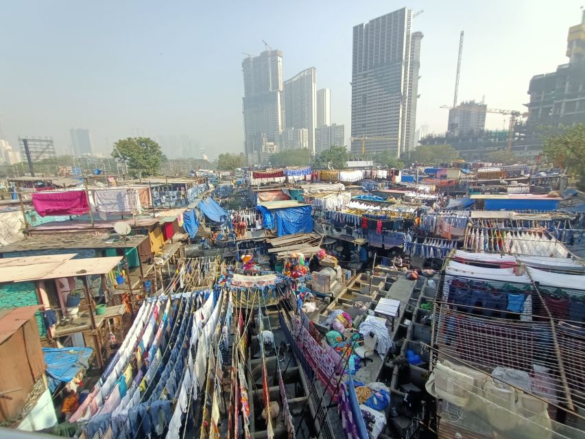Mumbai: Dhobi Ghat Tour with Dharavi and Train Ride Options - Following the clothes from washing to pressing